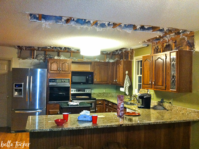 Kitchen popcorn ceilings with damage from the soffit tear out.