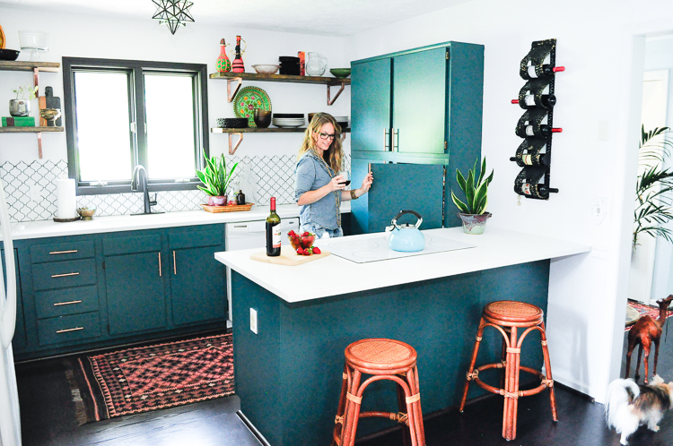 Erin Sparks in her updated kitchen with Sherwin Williams 0064 Blue Peacock Cabinets- photo by Samantha Nelson Photography