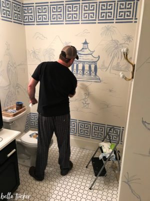 Brooks Tucker sketching out chinoiserie mural with chalk.