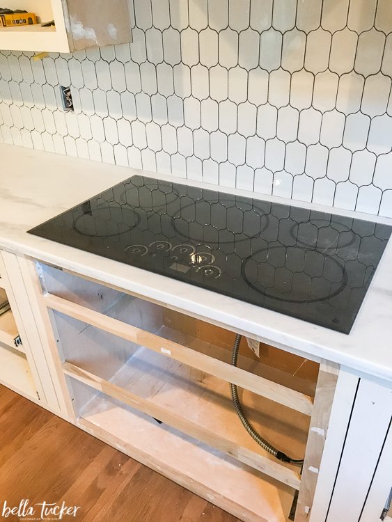 Picket tile backsplash and induction cooktop