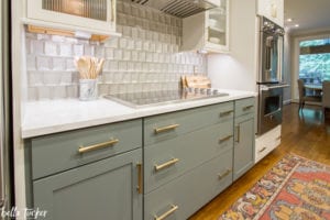 Relocated cooktop, new modern glass backsplash tile